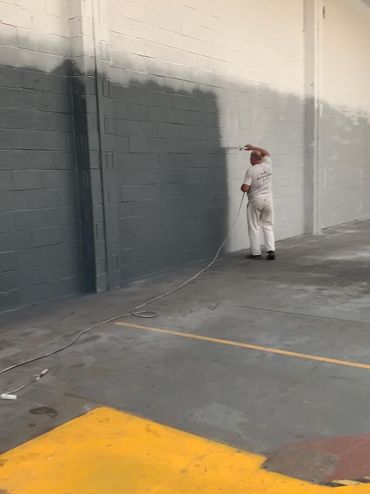 Paint Spraying the Interior Walls to an Industrial Warehouse Unit in Hamworthy - During Photo by Emerald Painters